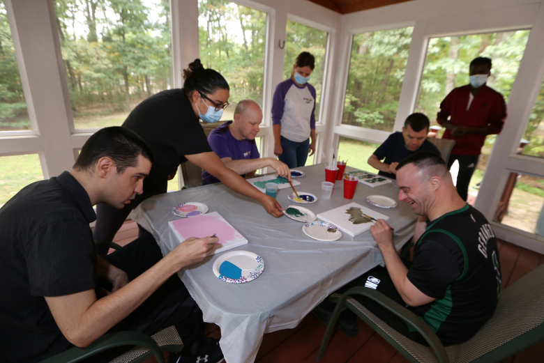 Littleton group residence creating project on screen porch with staff