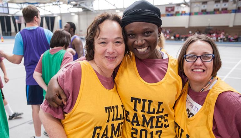 Three women at Till games sports yellow jerseys